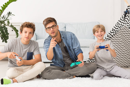 Dad playing video games with his sons