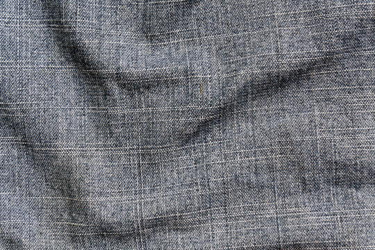 Blue color denim textile cloth surface.
