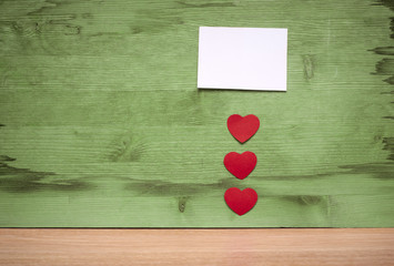 many small hearts and a blank sheet of paper to record