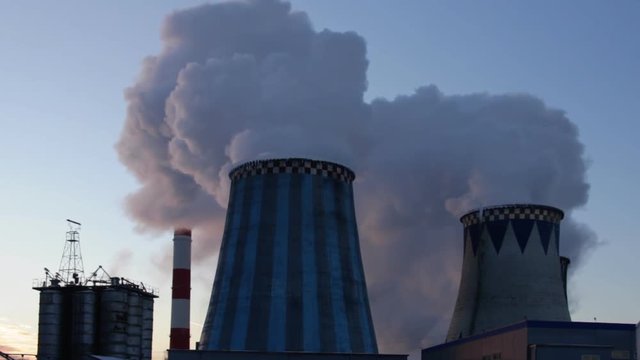 power plant emitting smoke and vapor in cold weather

