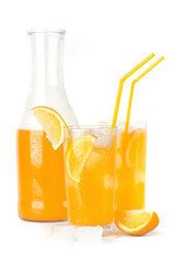 Glass bottle and two glasses with orange beverage