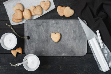 Fototapeta na wymiar Baked cookies-hearts prepared for icing
