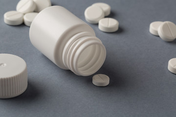 Various white plastic pill bottles and heap of drugs