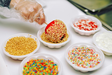 Dipping caramelized Apple in the nuts