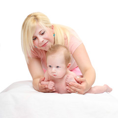 Obraz na płótnie Canvas Young mother takes care for her toddler. Parenting and child care theme. Parents and baby together. Studio shot of people on white background.