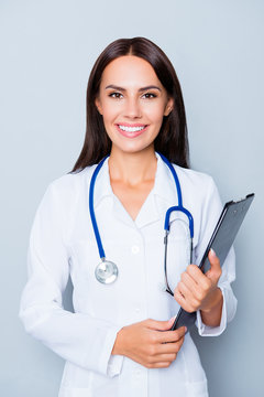 Happy young nurse holding folder isolated on lue background