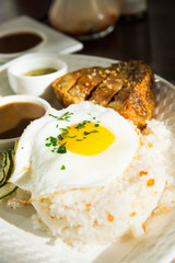 lechon kawali with garlic rice and egg on top
