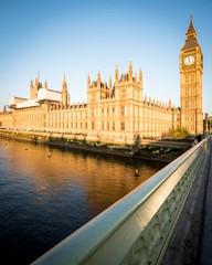 Fototapeta na wymiar Big Ben and the Palace of Westminster. Low angle view of the famous clock tower London landmark in the early morning sun.