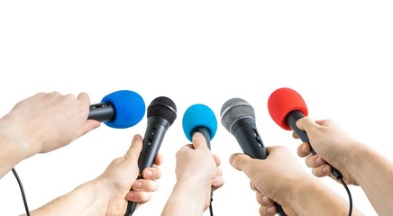 Journalism and conference concept. Many reporter hands hold microphones. Isolated on white...