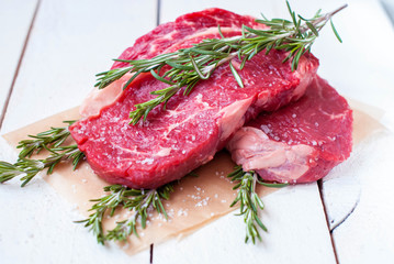 Beef raw steaks on a rough background