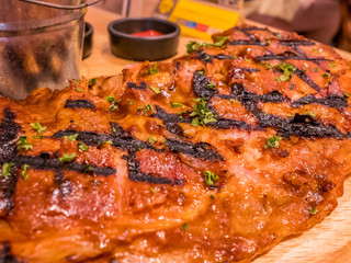 Close-up BBQ rib serve on wood board.
