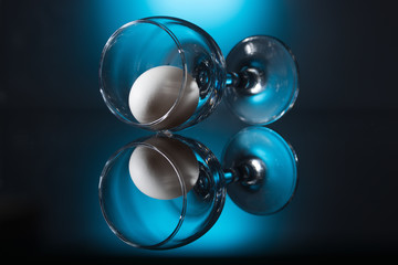 egg in a glass on a blue background
