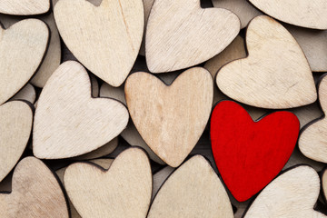 Obraz premium Wooden hearts, one red heart on the heart background.
