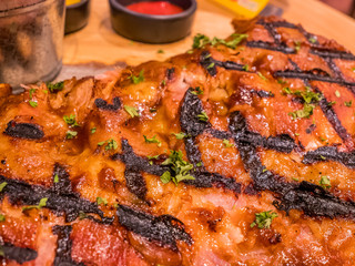 Close-up BBQ rib serve on wood board.