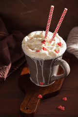 cup of coffee with whipped cream and red hearts