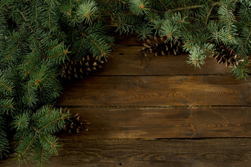 wood background with Christmas tree and pine cones