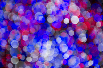 Colorful abstract background made from bokeh light bubbles in red, white, and blue, 