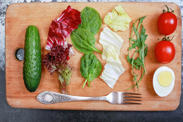 Tasty salad on the wooden board ingredients