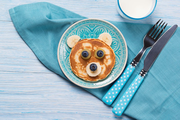 Funny pancake in a shape of teddy bear, food for kids idea, top view