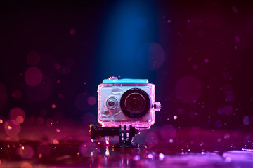 Concept: gear, gadget, action lifestyle, millennial. Vivid colorful shot of action camera in...