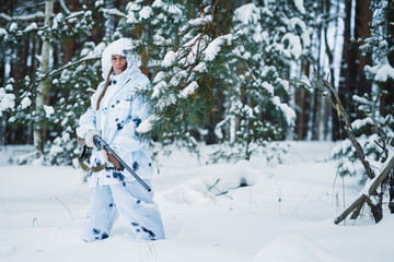 portrait of a beautiful girl in white camouflage hunter with a g