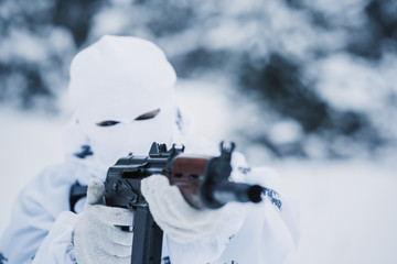 portrait of soldier in camouflage and white mask balaclava with