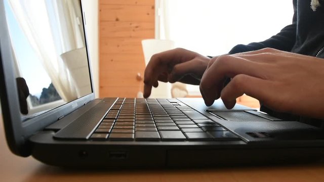 Man writing a text on his computer
