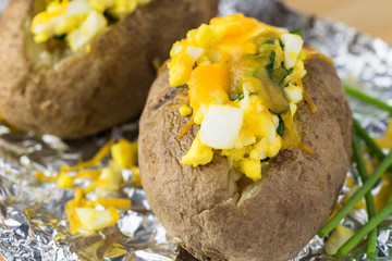 Loaded baked potatoes with eggs, spinach, cheese.
