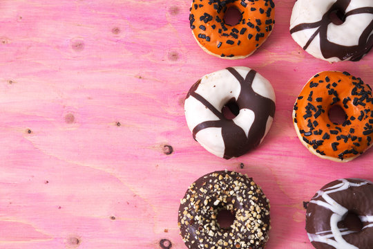 assortment of donuts on wooden background