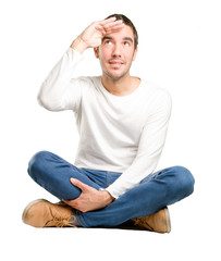 Obraz premium Seated young man with a sight gesture