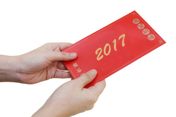 Chinese New Year concept of hand holding ang pow or red envelope
