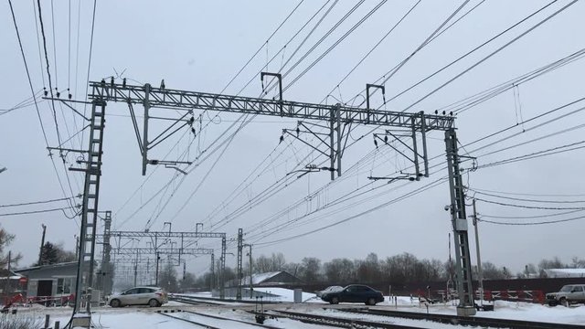Cars drive through the railway crossing in winter