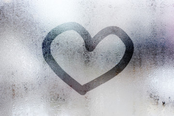 heart shape written on a foggy window