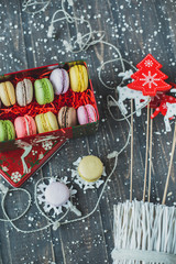 Christmas background with macaroons garlands and snow