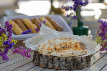 pita breabakery products, bread and bun. On a wooden board table terrace.d on wooden board