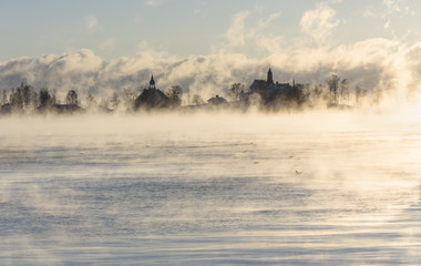 Island behind vaporing sea