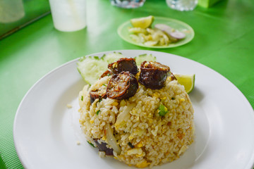 Fried rice with Thai spicy sausages Northern style.on green table