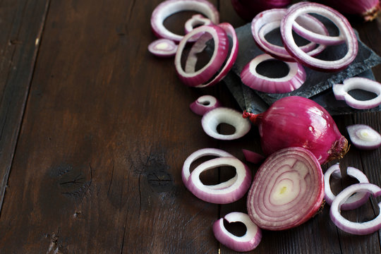 Red onions on a wooden table