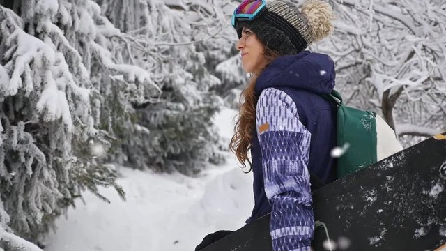 Footage of snowboarder woman adventure, walking to snowy alps mountains