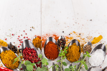 Various colorful spices on wooden table