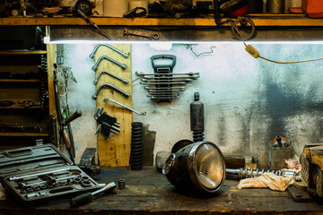 Motorcycle parts on the desktop in the garage