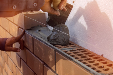 Bricklayer lays the mortar for laying brick. construction work