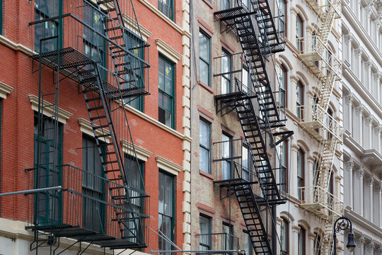 New York buildings with fire escape stairs, sunny day