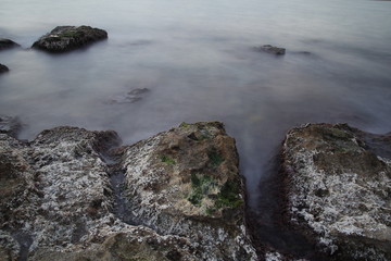 Sea coast in a long exposure shot, with blurred water