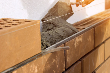 Bricklayer lays the mortar for laying brick. construction work