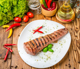 sirloin steak on a plate with sauce