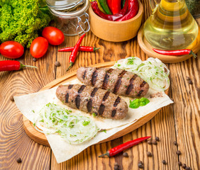 kebab meat with sauce on a wooden table