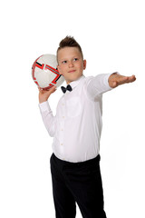 Młody chłopiec w białej koszuli trzyma piłkę na dłoni. - obrazy, fototapety, plakaty