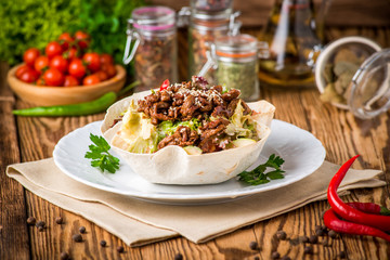 Doner kebab - fried chicken meat with vegetables in pita bread