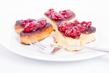 Heart shaped pancakes with cowberry jam
